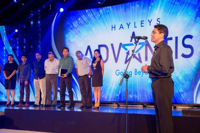 Hayleys Advantis event with a speaker addressing the audience and a group of participants on stage Hayleys Advantis event with a speaker addressing the audience and a group of participants on stage